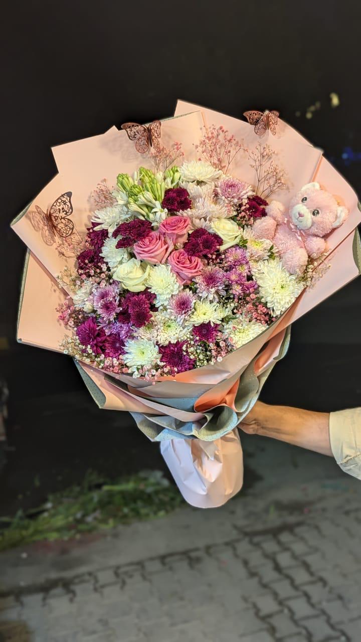 Chrysanthemum, Roses, Babe Breath, Tube Roses and Taddi Bouquet.
